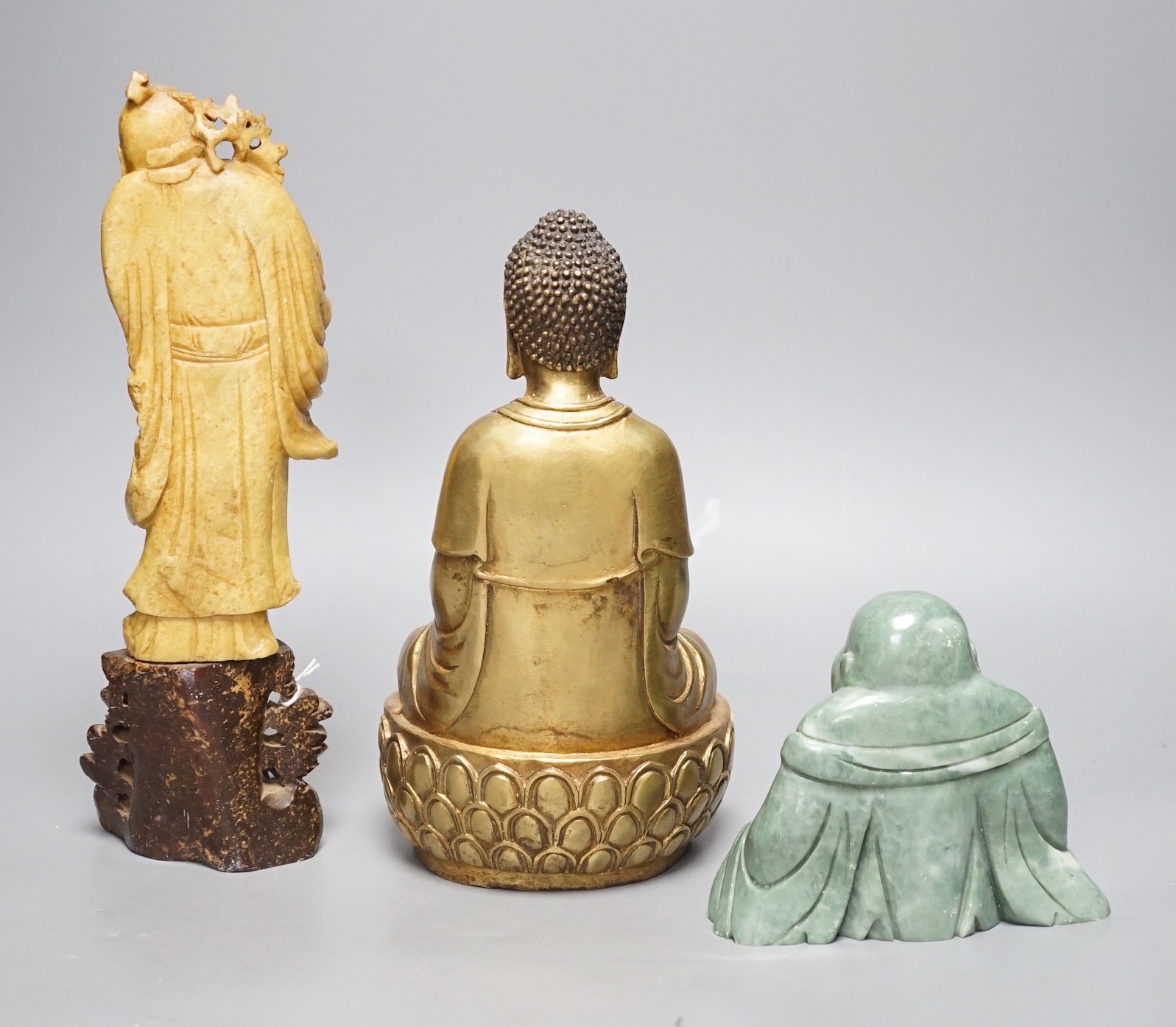 A Chinese greenstone Buddha, a soapstone carving of Shou Lao on carved hardwood stand, and a bronze figure of a seated Shaykamuni Buddha, tallest 29cm